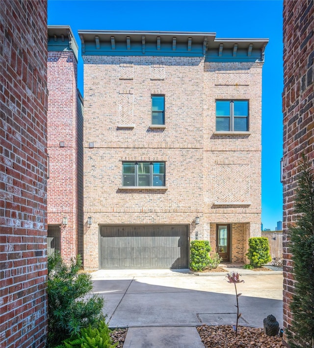 view of property featuring a garage and driveway