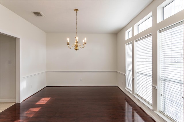 dining space with a chandelier, visible vents, baseboards, and wood finished floors