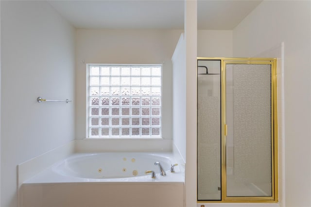 bathroom featuring a shower stall and a whirlpool tub