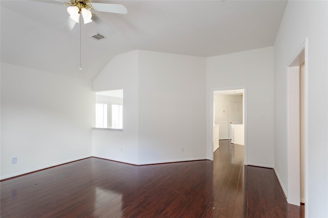 empty room with visible vents, lofted ceiling, wood finished floors, baseboards, and ceiling fan