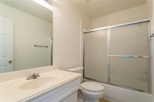 full bathroom with vanity, toilet, and shower / bath combination with glass door