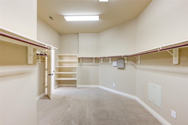 walk in closet featuring light colored carpet and visible vents