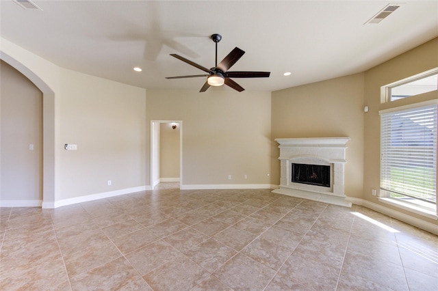 unfurnished living room with visible vents, recessed lighting, a premium fireplace, baseboards, and ceiling fan