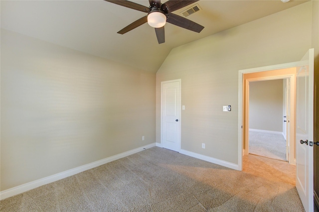 unfurnished bedroom featuring visible vents, baseboards, lofted ceiling, and carpet floors