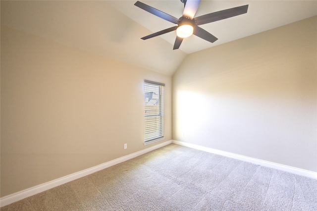 unfurnished room with lofted ceiling, a ceiling fan, baseboards, and carpet floors