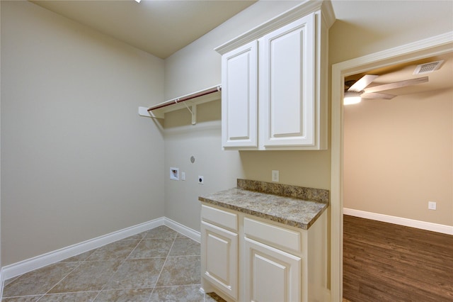 laundry area with cabinet space, hookup for an electric dryer, baseboards, and washer hookup