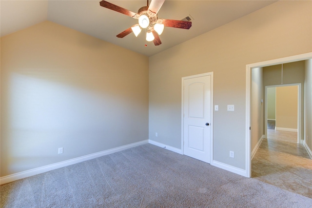 spare room with visible vents, baseboards, ceiling fan, lofted ceiling, and carpet flooring