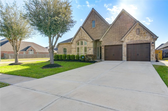 view of front facade featuring a front lawn, fence, and stone siding