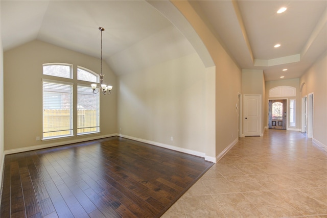 unfurnished room with recessed lighting, arched walkways, light wood-style floors, baseboards, and a chandelier