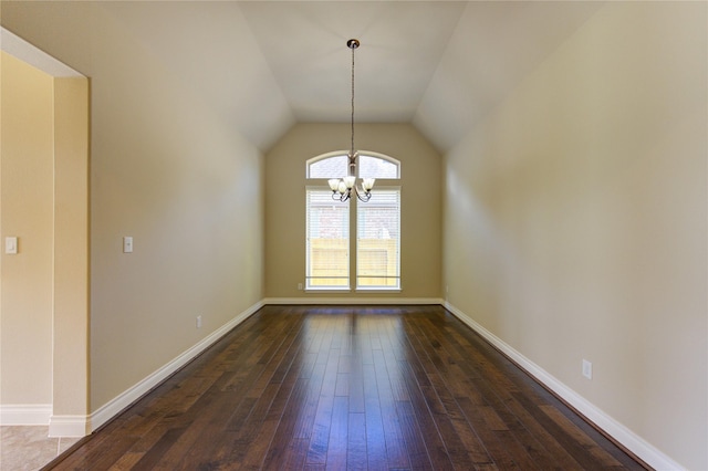 unfurnished dining area featuring a chandelier, dark wood finished floors, baseboards, and vaulted ceiling