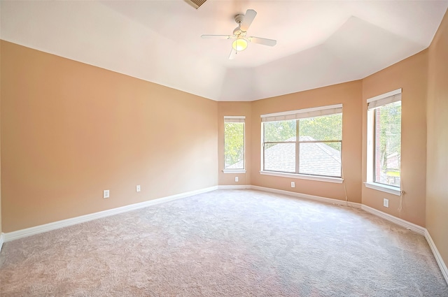 unfurnished room with a ceiling fan, visible vents, baseboards, vaulted ceiling, and carpet flooring