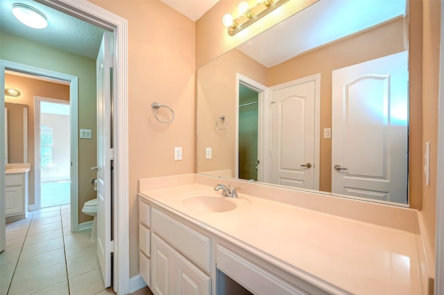 full bath featuring vanity, tile patterned floors, toilet, and a shower with shower door