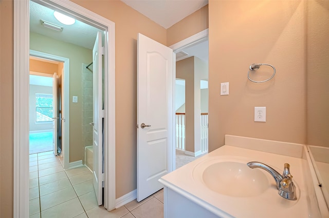 bathroom featuring vanity, baseboards, visible vents, walk in shower, and tile patterned floors