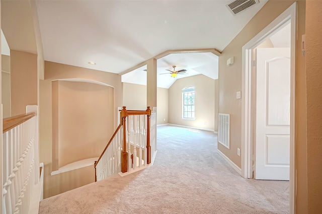 corridor featuring lofted ceiling, an upstairs landing, visible vents, and carpet floors