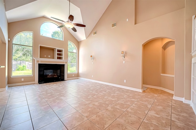 unfurnished living room featuring visible vents, a healthy amount of sunlight, ceiling fan, and light tile patterned flooring