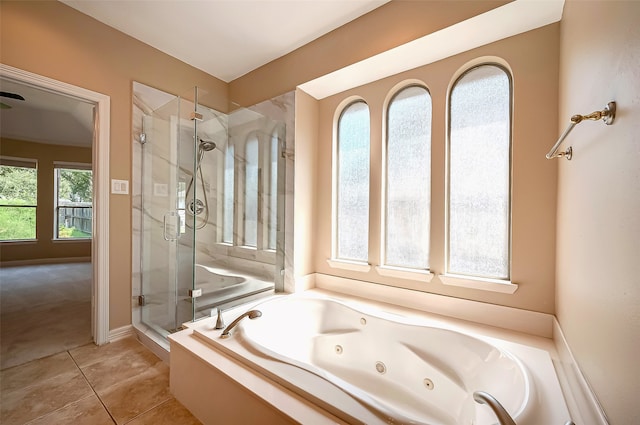 full bath featuring a jetted tub, a shower stall, and tile patterned flooring