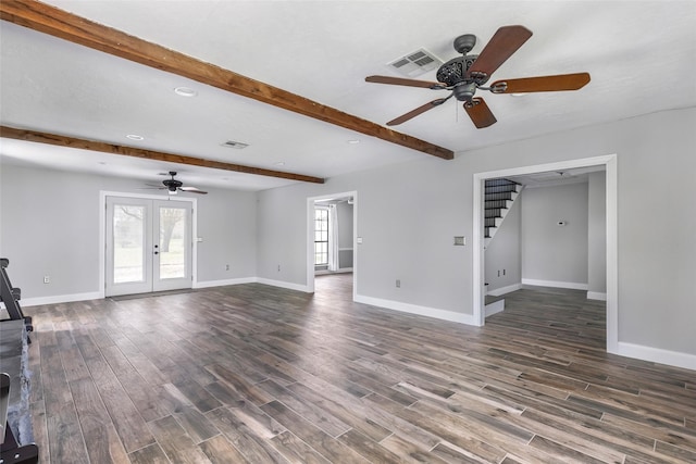 unfurnished living room with beamed ceiling, dark wood-style floors, baseboards, ceiling fan, and stairs