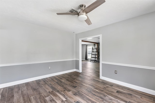 unfurnished room with baseboards, dark wood-style floors, and a ceiling fan