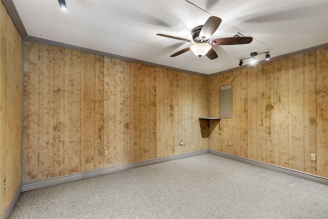 carpeted empty room with electric panel, baseboards, and ceiling fan