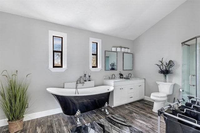 bathroom with a shower stall, lofted ceiling, wood finished floors, a soaking tub, and vanity