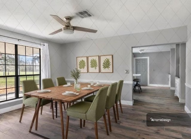 dining room featuring visible vents, baseboards, a ceiling fan, and wood finished floors