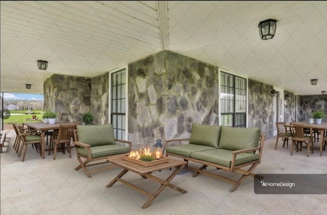 view of patio with outdoor dining space and an outdoor living space with a fire pit