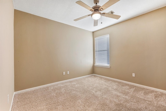 unfurnished room with carpet flooring, baseboards, visible vents, and ceiling fan