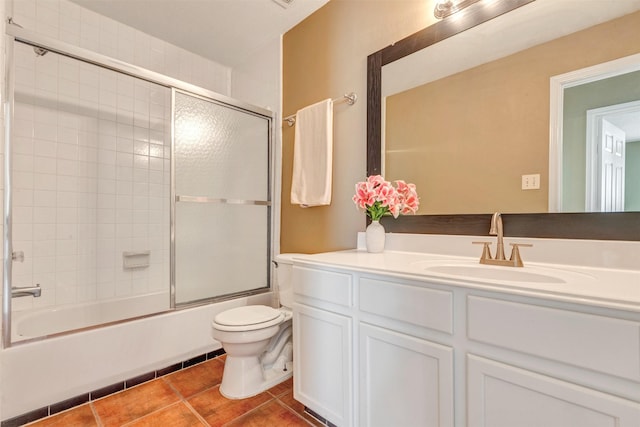 full bathroom featuring vanity, tile patterned floors, toilet, and combined bath / shower with glass door