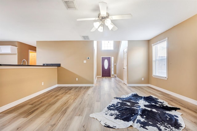 entrance foyer featuring visible vents, baseboards, light wood-style floors, and a ceiling fan