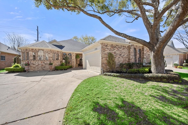 view of front of property with a front lawn, driveway, an attached garage, a shingled roof, and brick siding