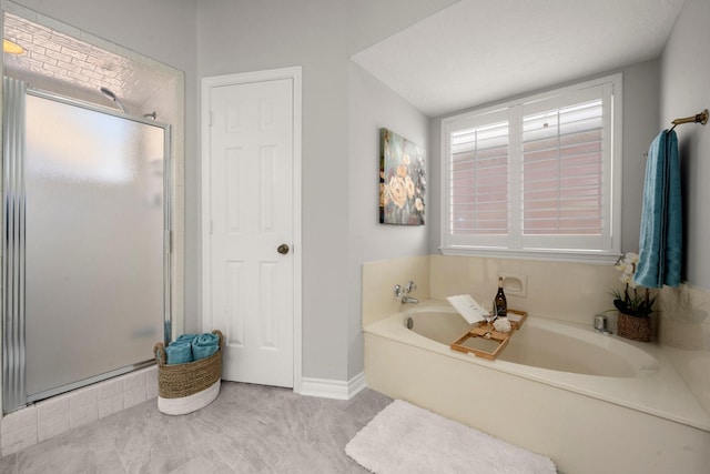 bathroom with a garden tub and a stall shower