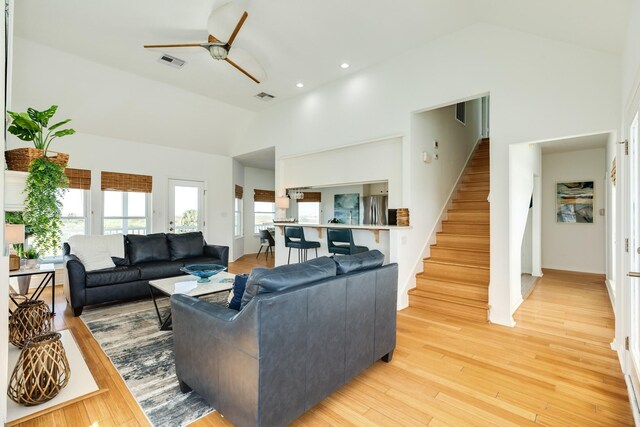 4010 Kiva Rd, Galveston, TX 77554 - living area featuring ceiling fan, high vaulted ceiling, stairway, light wood-style flooring, and recessed lighting