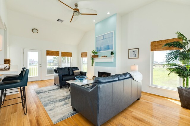 4010 Kiva Rd, Galveston, TX 77554 - living area with ceiling fan, a fireplace, high vaulted ceiling, light wood finished floors, and recessed lighting
