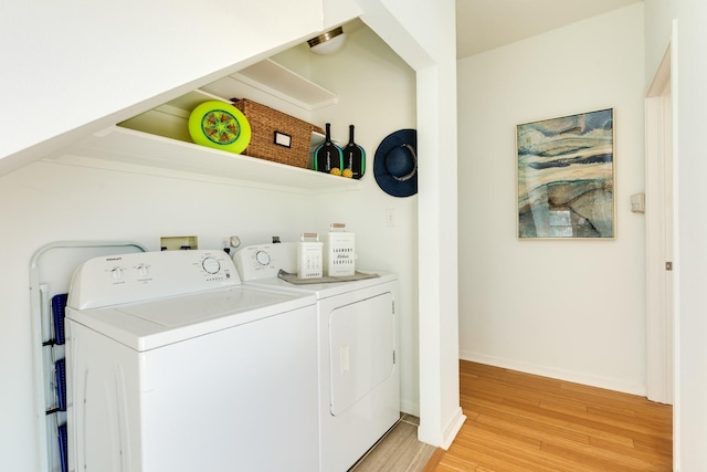 4010 Kiva Rd, Galveston, TX 77554 - washroom featuring washing machine and dryer, light wood-type flooring, and baseboards