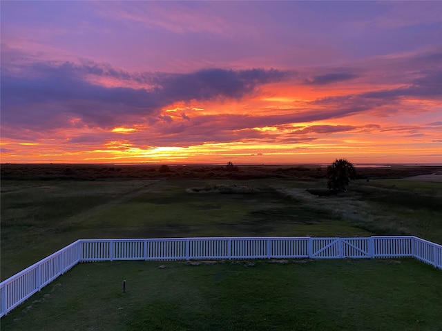 4010 Kiva Rd, Galveston, TX 77554 - yard at dusk with a rural view and a fenced backyard