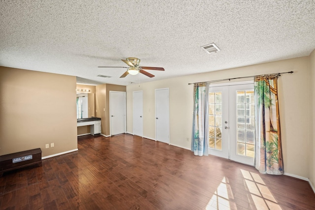 interior space featuring a ceiling fan, wood finished floors, visible vents, and french doors