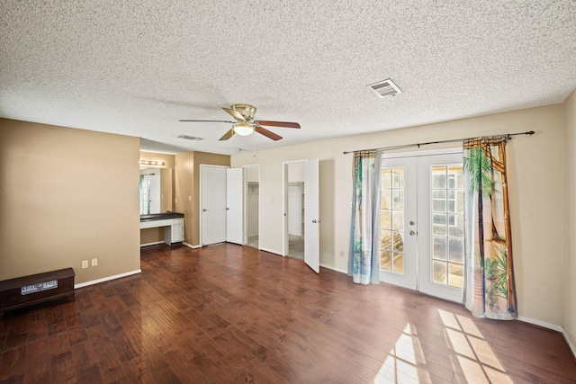 interior space with visible vents, french doors, ceiling fan, and wood finished floors