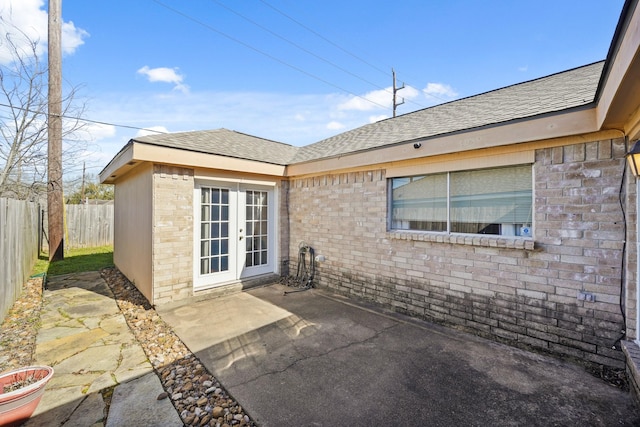 exterior space with french doors and fence