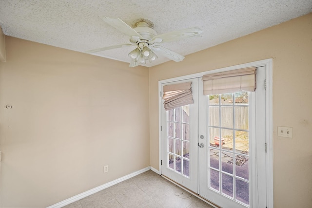 empty room featuring a ceiling fan, a textured ceiling, french doors, light tile patterned floors, and baseboards