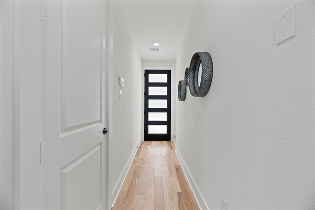 424 Sikes Unit C, Houston, TX 77018 - doorway to outside featuring light wood-style floors and baseboards