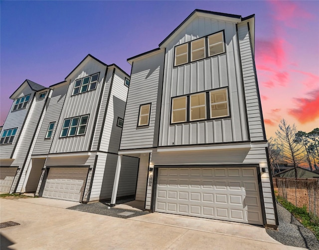 view of front of house featuring driveway, board and batten siding, and an attached garage