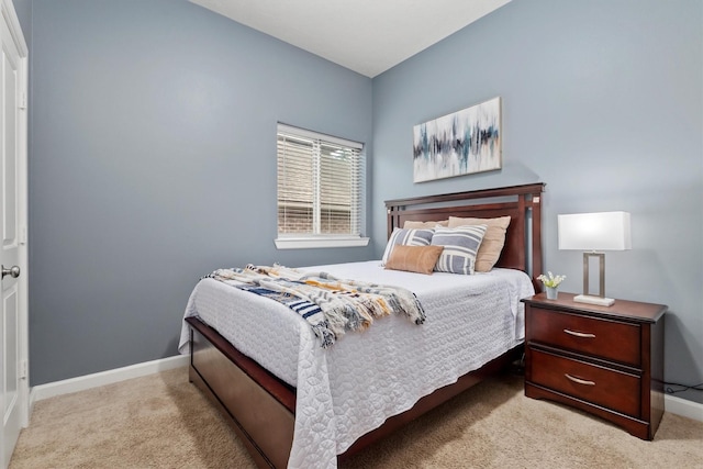 carpeted bedroom featuring baseboards