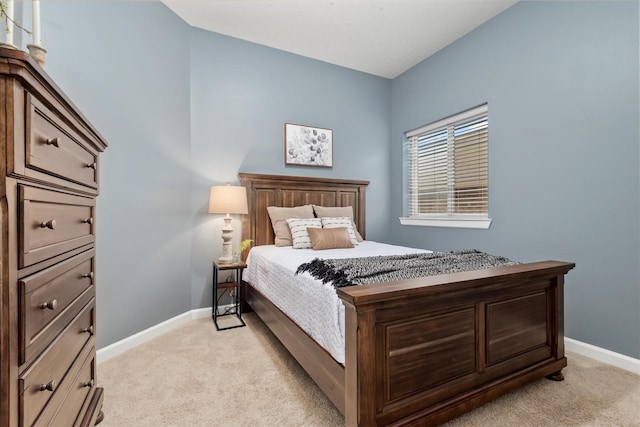 bedroom featuring baseboards and light carpet