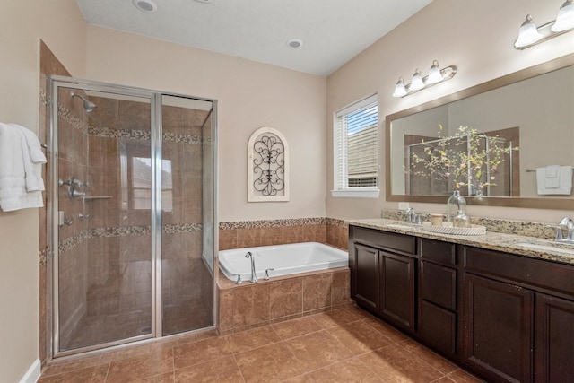 bathroom with a sink, a garden tub, a stall shower, and double vanity