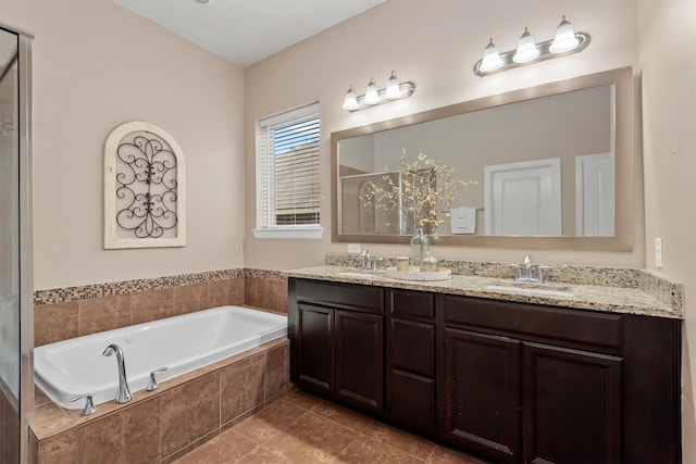 bathroom featuring a sink, a garden tub, a stall shower, and double vanity