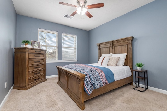 bedroom with visible vents, light colored carpet, a ceiling fan, and baseboards