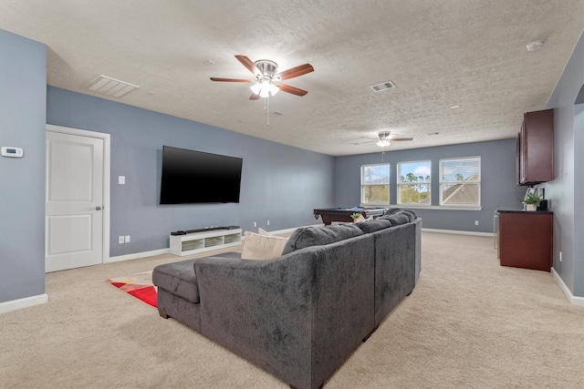 living area featuring visible vents, light colored carpet, and a ceiling fan