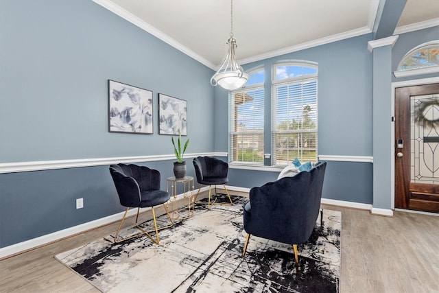 sitting room with wood finished floors, baseboards, and ornamental molding