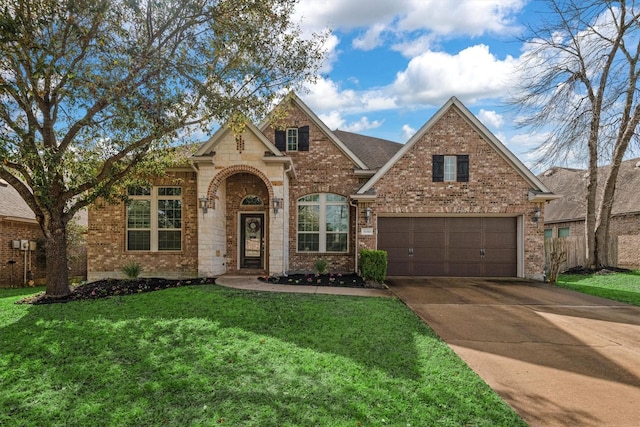 traditional home with concrete driveway, fence, brick siding, and a front lawn