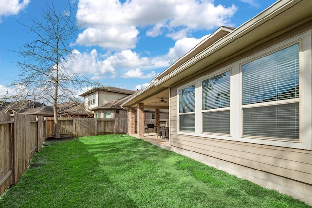 view of yard featuring a fenced backyard, a patio, and ceiling fan